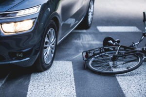 a-bicycle-lying-in-the-road-beside-a-car-after-a-bicycle-accident