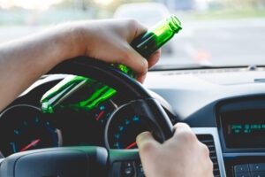 a-driver-holding-a-beer-bottle-and-committing-a-dui