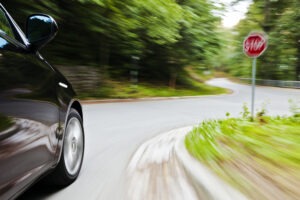 A car recklessly approaching a stop sign. A reckless driving accident lawyer can help you after a collision.